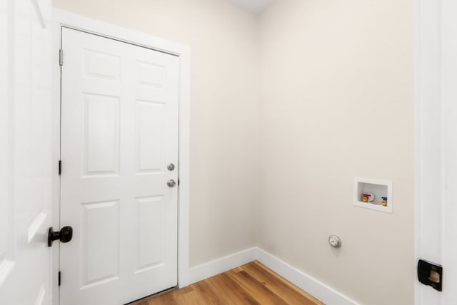 washroom featuring light wood-type flooring, baseboards, hookup for a washing machine, and laundry area