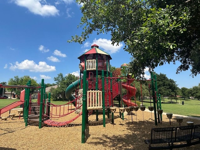 communal playground featuring a lawn