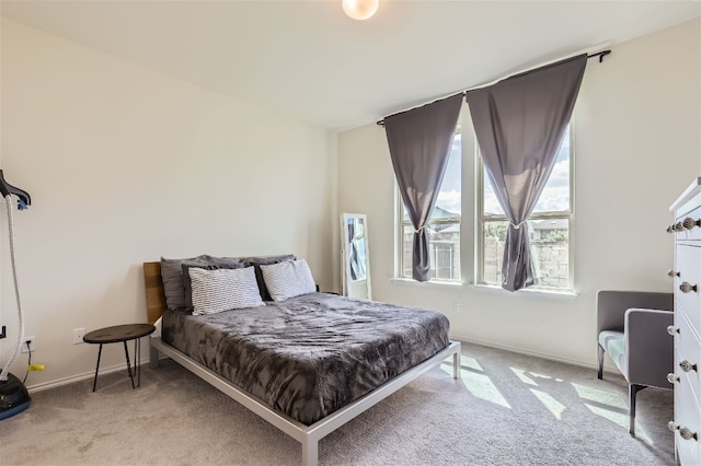 carpeted bedroom with baseboards