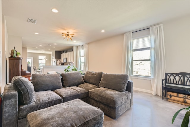 living room featuring recessed lighting, visible vents, plenty of natural light, and concrete floors