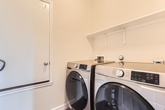 clothes washing area featuring washing machine and clothes dryer and laundry area