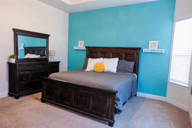 bedroom with baseboards and carpet