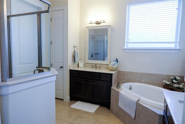 full bath featuring vanity, a bath, tile patterned flooring, and walk in shower