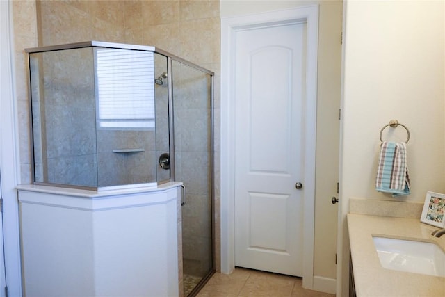 bathroom featuring tile patterned floors, vanity, and a shower stall