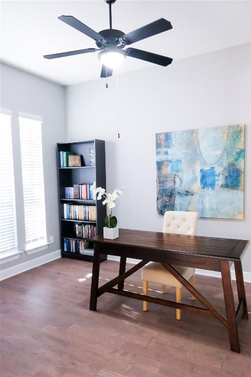 office area featuring baseboards, a ceiling fan, and wood finished floors