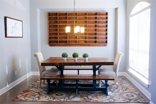 dining room with an inviting chandelier, plenty of natural light, and baseboards