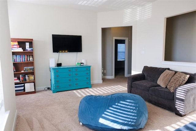 living room featuring carpet flooring and baseboards