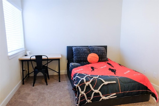 bedroom with carpet flooring and baseboards