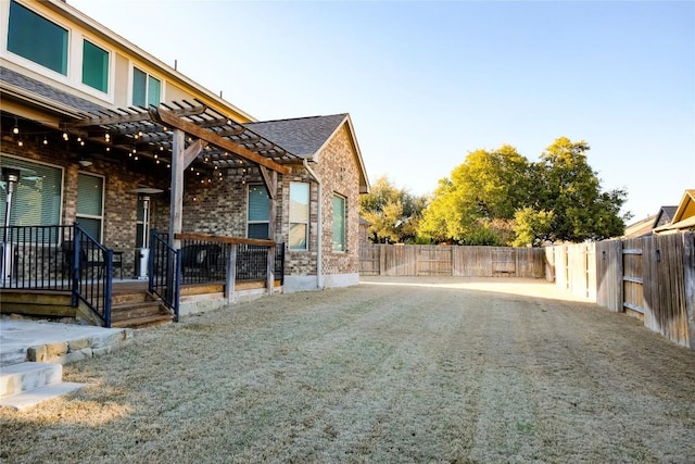 view of yard with a pergola and a fenced backyard