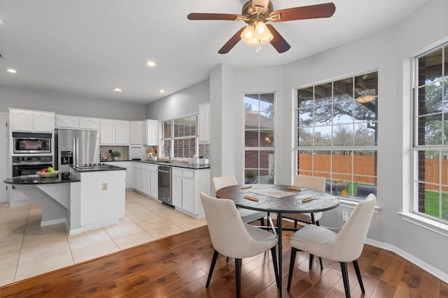 dining area with ceiling fan, recessed lighting, light wood-type flooring, and baseboards