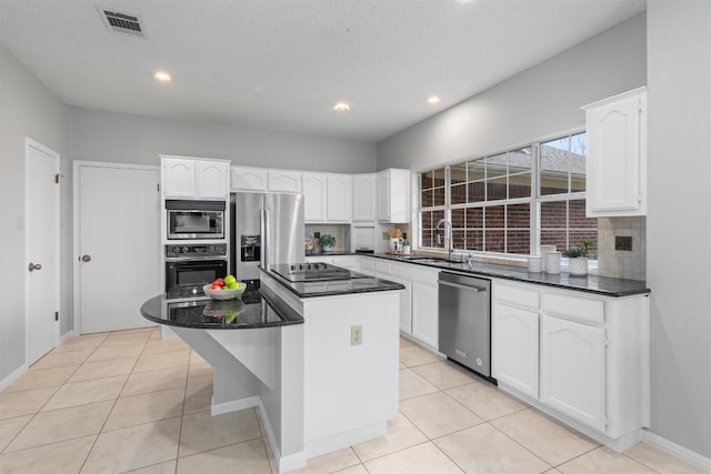 kitchen with visible vents, light tile patterned flooring, a sink, black appliances, and white cabinets