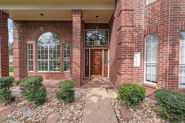 doorway to property with brick siding