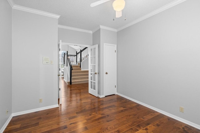 unfurnished room with stairway, baseboards, hardwood / wood-style floors, and a ceiling fan