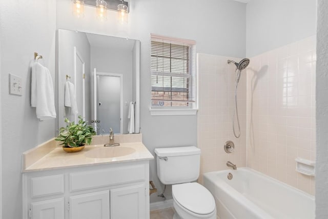 bathroom featuring vanity, toilet, and shower / washtub combination