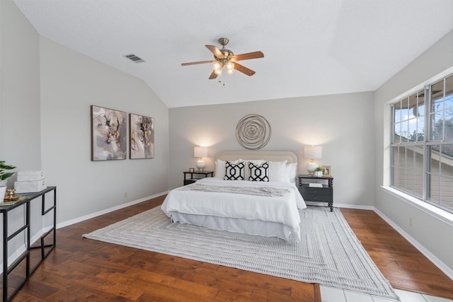 bedroom featuring baseboards, visible vents, ceiling fan, hardwood / wood-style flooring, and vaulted ceiling