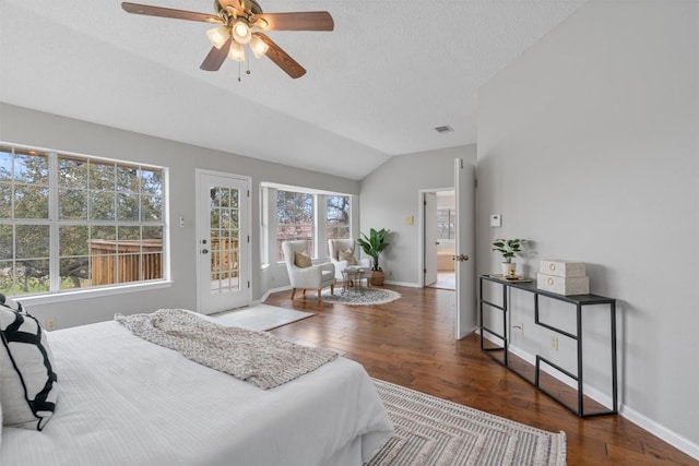 bedroom featuring vaulted ceiling, wood finished floors, visible vents, and access to outside