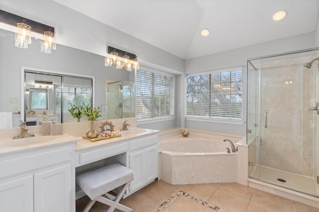 full bath with double vanity, a sink, vaulted ceiling, a shower stall, and a garden tub