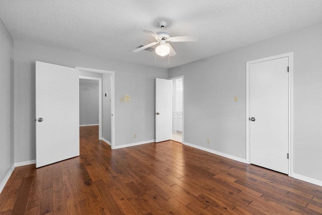 unfurnished bedroom featuring baseboards, a textured ceiling, and hardwood / wood-style flooring