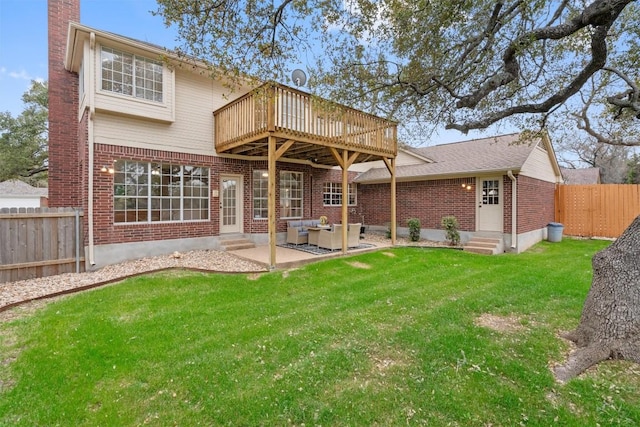 rear view of property with brick siding, entry steps, a chimney, a yard, and a fenced backyard