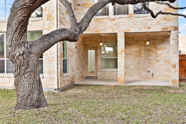 6717 Blissfield Dr, Austin, TX 78739 - entrance to property with stone siding and a yard