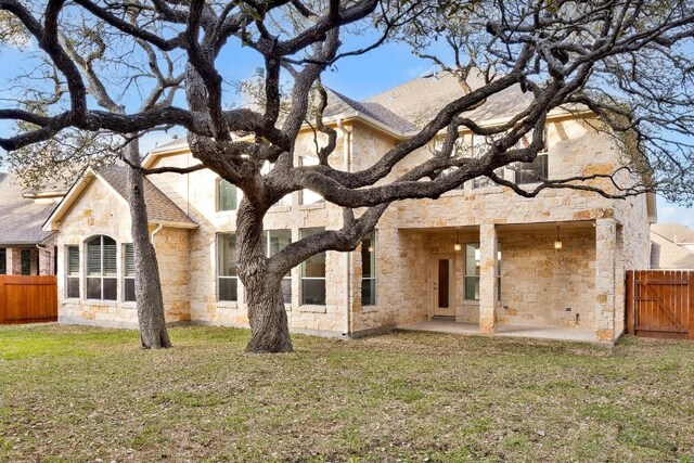 6717 Blissfield Dr, Austin, TX 78739 - rear view of house with stone siding and a patio