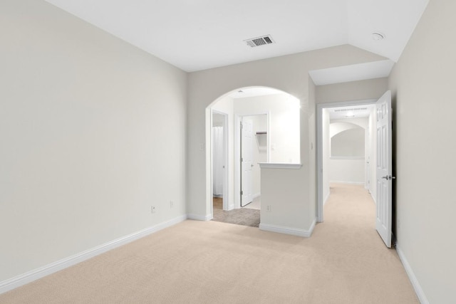 6717 Blissfield Dr, Austin, TX 78739 - unfurnished bedroom featuring arched walkways, light colored carpet, and a spacious closet