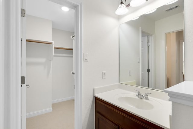 bathroom with visible vents, vanity, and baseboards