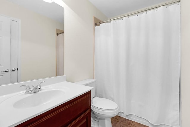 bathroom with a shower with curtain, toilet, vanity, and tile patterned flooring