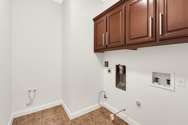 laundry room with electric dryer hookup, washer hookup, cabinet space, baseboards, and gas dryer hookup