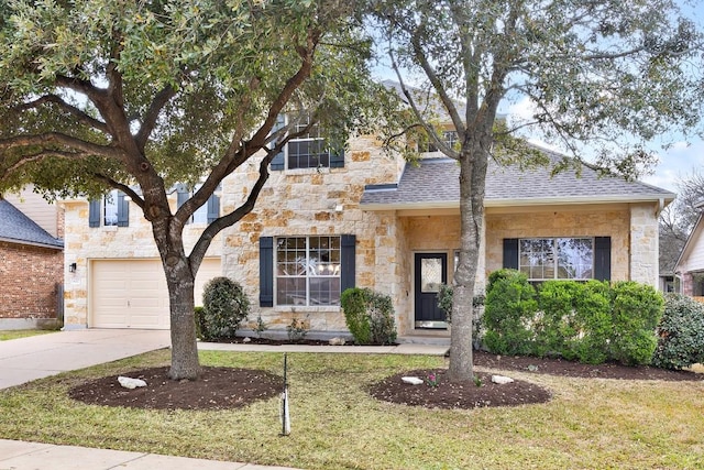 view of front of house with concrete driveway, a front yard, stone siding, and roof with shingles