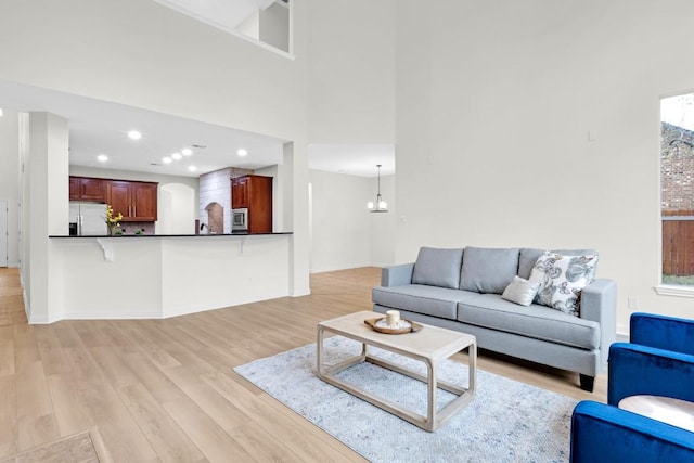6717 Blissfield Dr, Austin, TX 78739 - living area with light wood-style flooring, recessed lighting, and a high ceiling