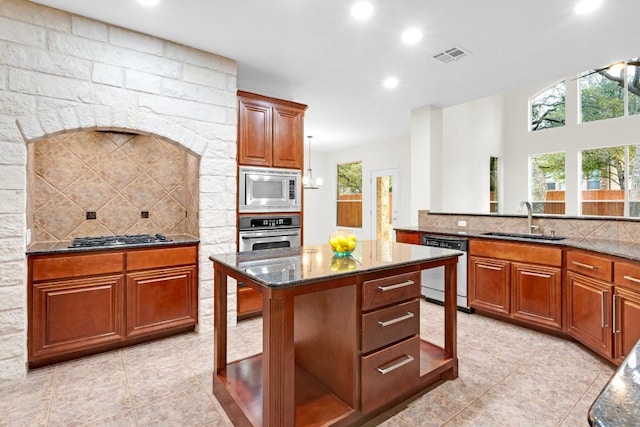 6717 Blissfield Dr, Austin, TX 78739 - kitchen with appliances with stainless steel finishes, dark stone counters, healthy amount of natural light, tasteful backsplash, and recessed lighting
