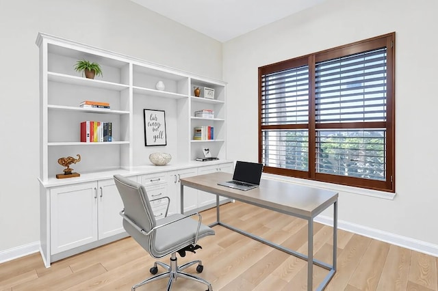 office area featuring baseboards and light wood-type flooring