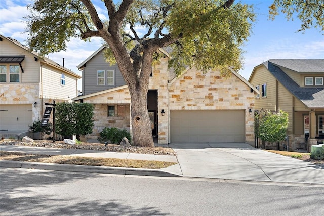 view of front of house with concrete driveway, an attached garage, and stone siding