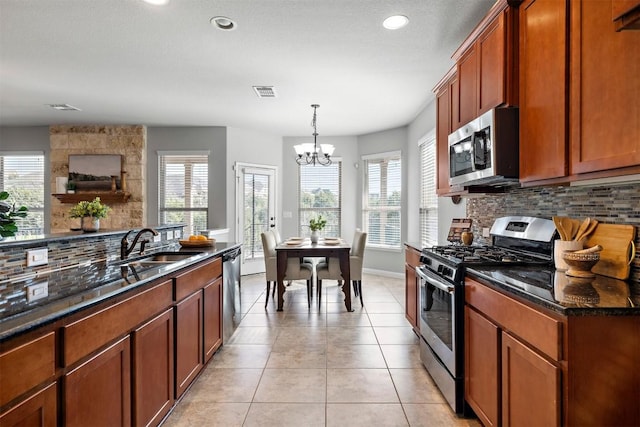 kitchen with tasteful backsplash, visible vents, light tile patterned floors, appliances with stainless steel finishes, and a sink