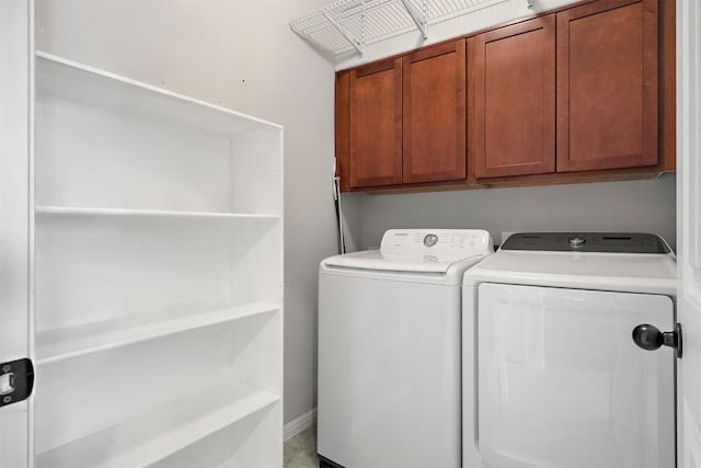 laundry room with cabinet space and separate washer and dryer