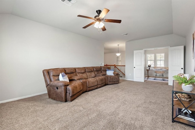 carpeted living room with vaulted ceiling, baseboards, visible vents, and ceiling fan