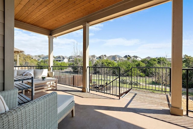 view of patio / terrace with a balcony and a residential view