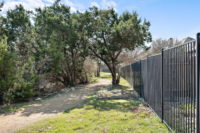 view of yard with fence and driveway