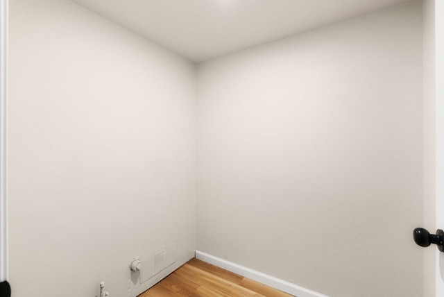 empty room with visible vents, baseboards, and light wood finished floors