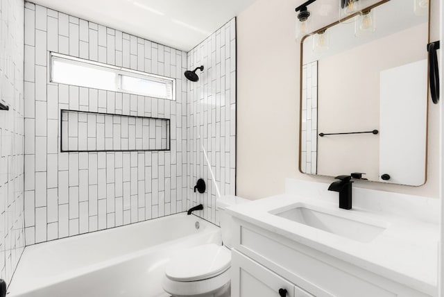 bathroom with toilet, vanity, and  shower combination