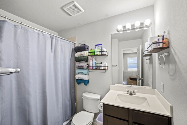 bathroom with vanity, toilet, a shower with curtain, and visible vents