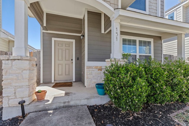 property entrance featuring stone siding