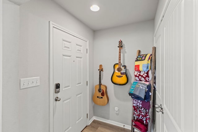 foyer entrance with light wood-type flooring and baseboards