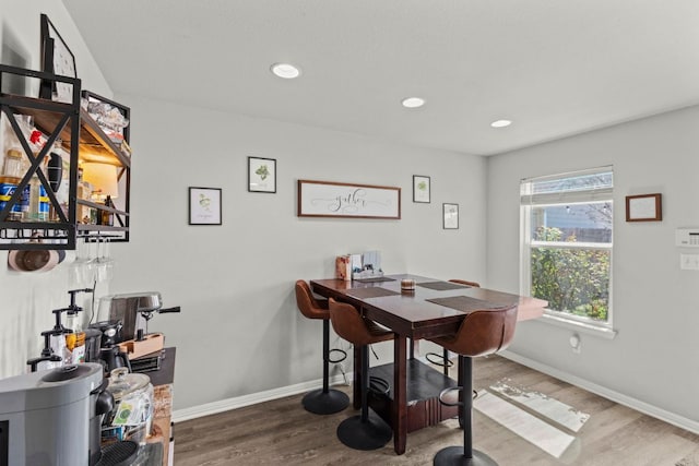 dining room with recessed lighting, baseboards, and wood finished floors