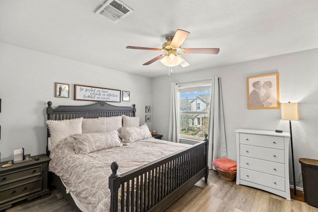 bedroom featuring visible vents, ceiling fan, and wood finished floors