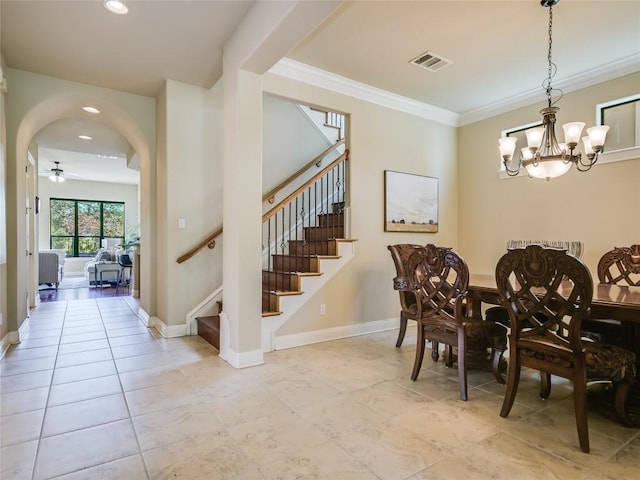 dining room featuring visible vents, ceiling fan with notable chandelier, stairway, crown molding, and baseboards