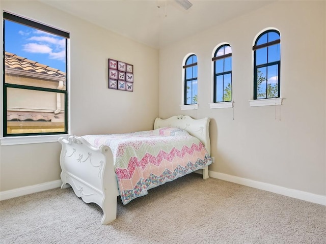 carpeted bedroom featuring baseboards