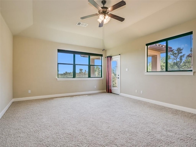 unfurnished room featuring visible vents, a ceiling fan, plenty of natural light, baseboards, and light colored carpet