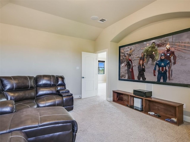 carpeted cinema featuring lofted ceiling, baseboards, and visible vents